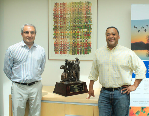 Artist poses with | Canadian Race Relations Foundation Representative | CRRF | with newly acquired Bronze Copy | Freedom In View | Bronze Sculpture | Harriott Tubman | Leads a small group to freedom in Canada via The Underground Railroad
